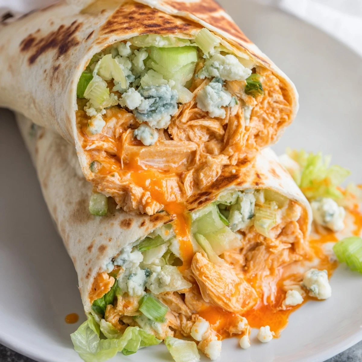 Golden-brown buffalo chicken dip wrap, filled with creamy, spicy chicken and fresh veggies, ready to eat.