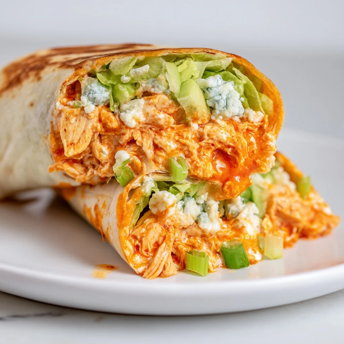 A close-up of a sizzling buffalo chicken dip wrap, grilling for a perfect, crispy texture.
