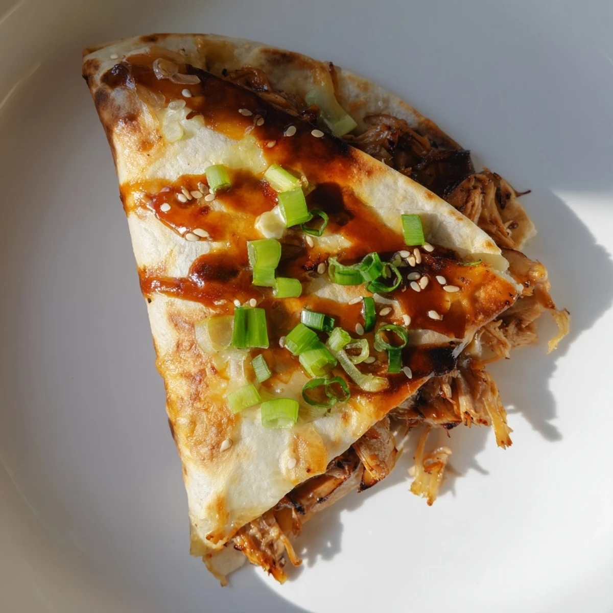 Golden, grilled Korean BBQ chicken wraps oozing with melted cheese, sesame seeds sprinkled on top.