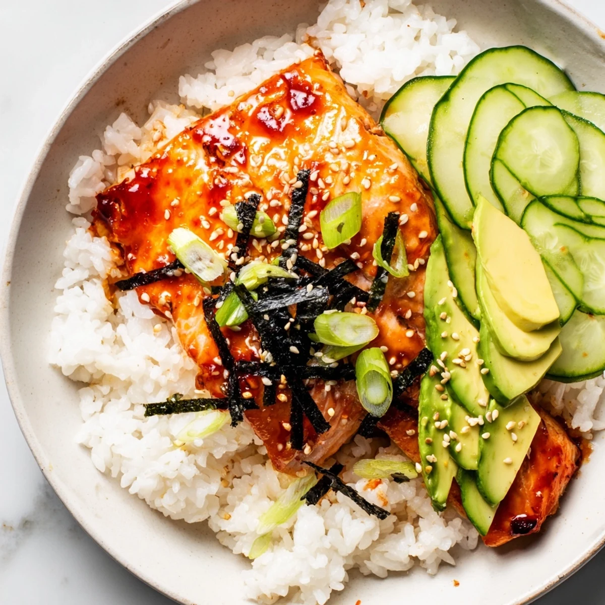 This Emily Mariko-inspired salmon bowl features tender salmon with a bright, spicy glaze, ready to eat.