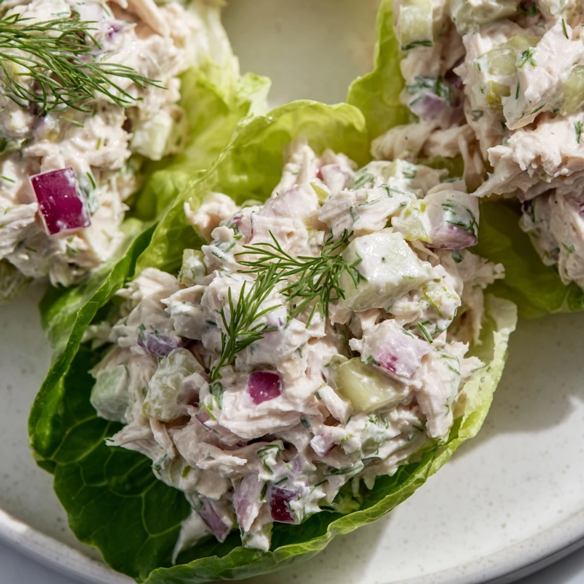 Fresh Dill Pickle Chicken Salad Lettuce Cups filled with crunchy pickles and creamy dressing, served in crisp butter lettuce.