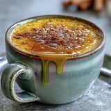 Golden milk latte in a rustic ceramic mug beside whole spices, perfect for a cozy, anti-inflammatory beverage moment.