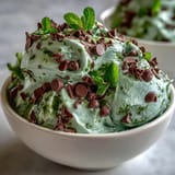 Creamy mint chocolate chip dip with shamrock sprinkles, perfect for St. Patrick's Day celebrations.