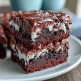 Fudgy brownie bites topped with white icing laces, crafted to look like baseballs for game day fun.
