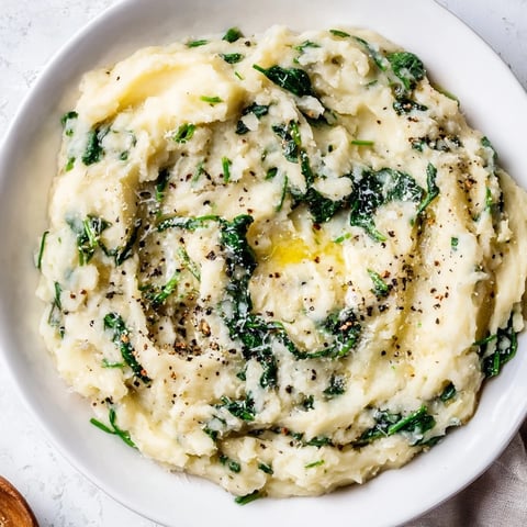 Creamy spinach and Parmesan mashed potatoes: a rich, comforting side, showing a fluffy, speckled potato mash.