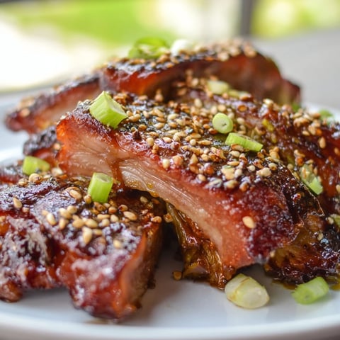 Golden-brown Crispy Honey-Soy Glazed Brussels Sprouts, glistening with sweet glaze and sesame seeds.