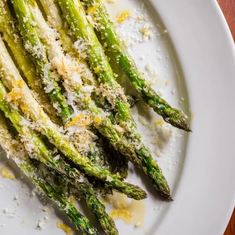Golden-brown roasted asparagus with bright lemon zest and Parmesan, ready to serve as a side.
