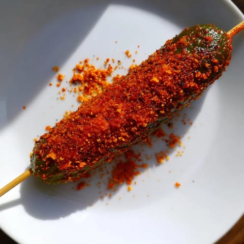 Crisp dill pickles transformed into Chamoy-Tajín pickle sticks, a sweet, spicy treat from Mexican street food.