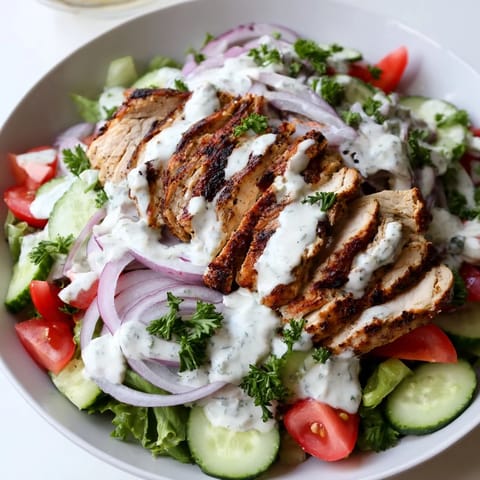 Golden-brown grilled Chicken Shawarma Salad ingredients arranged in a fresh bowl, ready for a creamy yogurt dressing and a squeeze of lemon. 