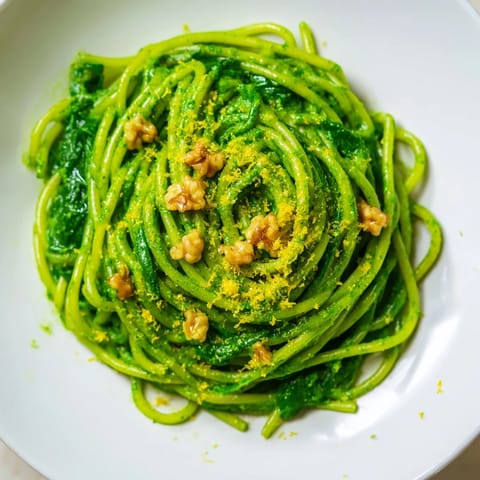 Fresh green sauce coats al dente pasta, with toasted walnuts adding texture to this vibrant, plant-based dinner.  