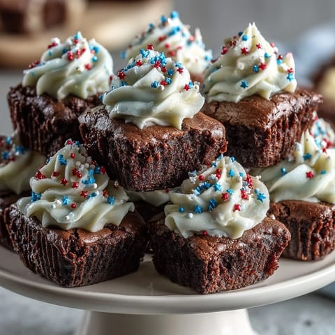 Festive firecracker brownie bites with sparkler toppers and patriotic sprinkles, perfect for Independence Day celebrations.  
