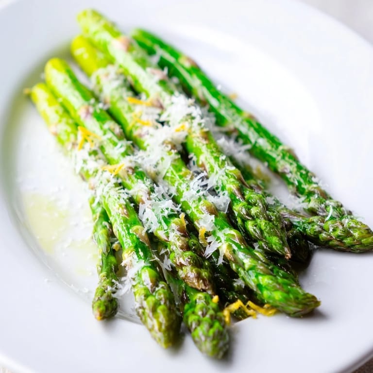 Tender-crisp roasted asparagus, tossed with Parmesan and lemon, a simple yet flavorful side dish.