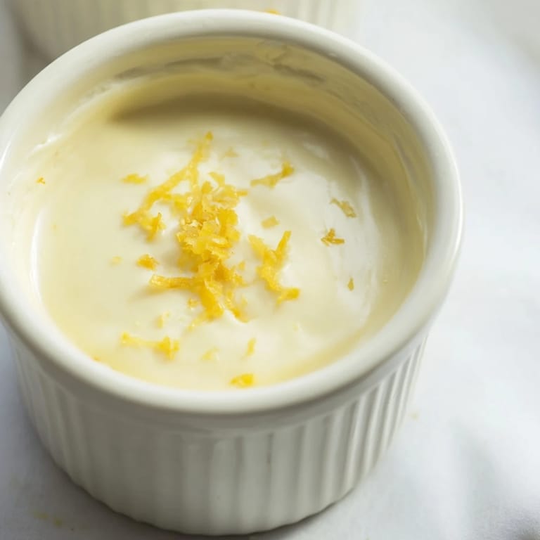 Silky smooth 3-Ingredient Lemon Posset, garnished with fresh berries ready to be enjoyed.