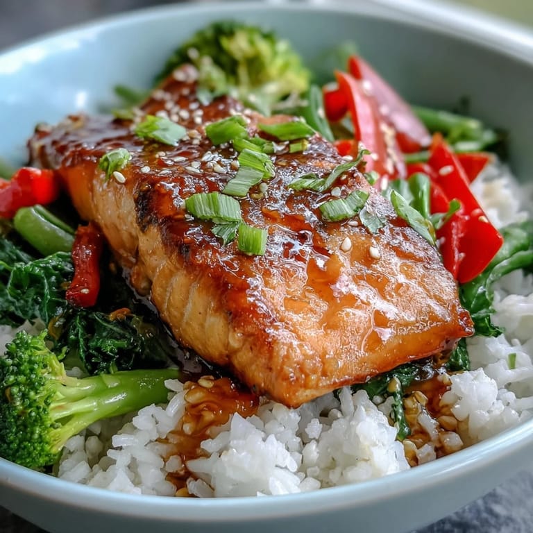 Savory-sweet Teriyaki Salmon Bowl garnished with sesame seeds and scallions, served ready for a satisfying dinner.