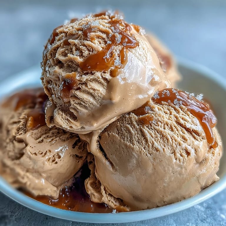 A scoop of Hojicha Ice Cream, topped with sweetened condensed milk for serving.