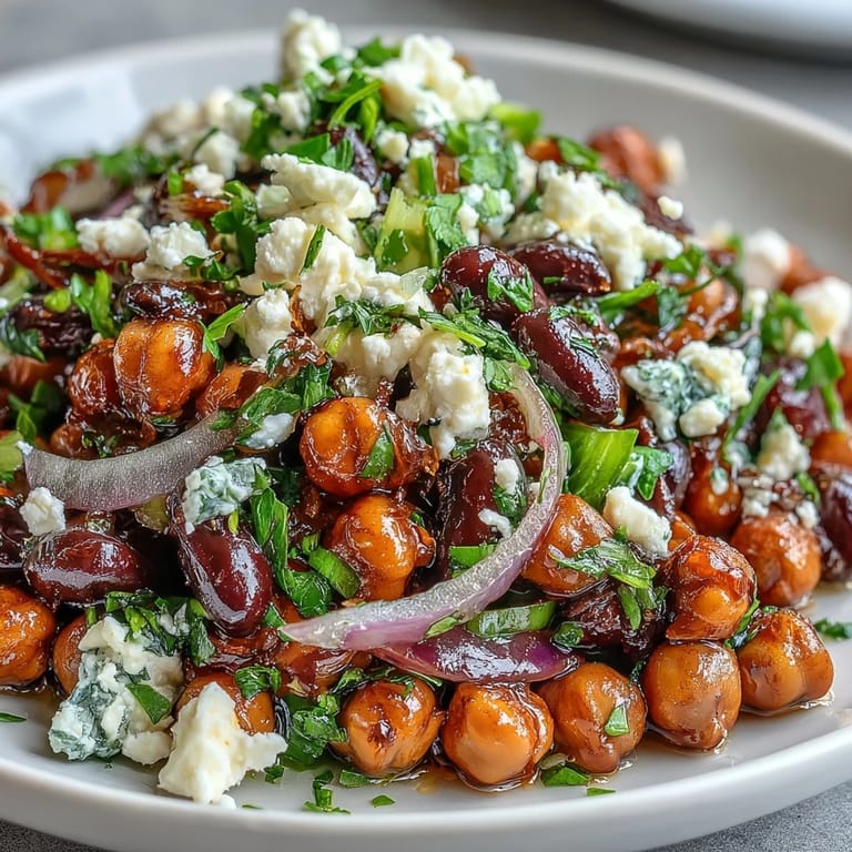 Close-up of chilled Divorce Salad, showcasing marinated beans, crumbled feta, and bright herbs in a simple, meal-prep friendly Mediterranean bowl.  